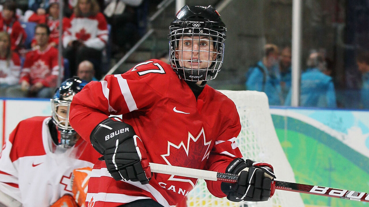 VANCOUVER, BC - FEBRUARY 15: Gina Kingsbury #27 of Canada looks for an open pass during the Women's preliminary game between Switzerland and Canada on day 4 of the Vancouver 2010 Winter Olympics at the UBC Thunderbird Arena on February 15, 2010 in Vancouver, Canada.
