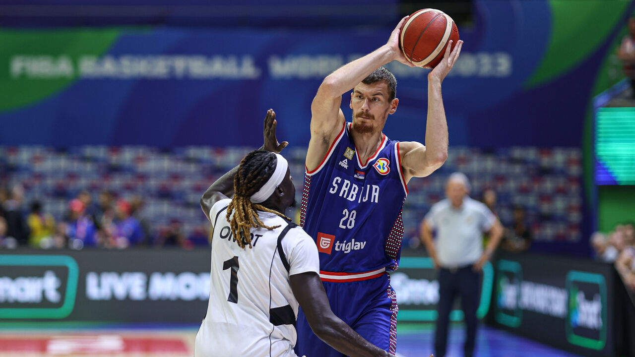 MANILA, PHILIPPINES - AUGUST 30: Borisa Simanic #28 of Serbia drives the ball against Nuni Omot #1 of South Sudan during the first round Group B match between South Sudan and Serbia on day 6 of the FIBA Basketball World Cup at Araneta Coliseum on August 30, 2023 in Manila, Philippines.