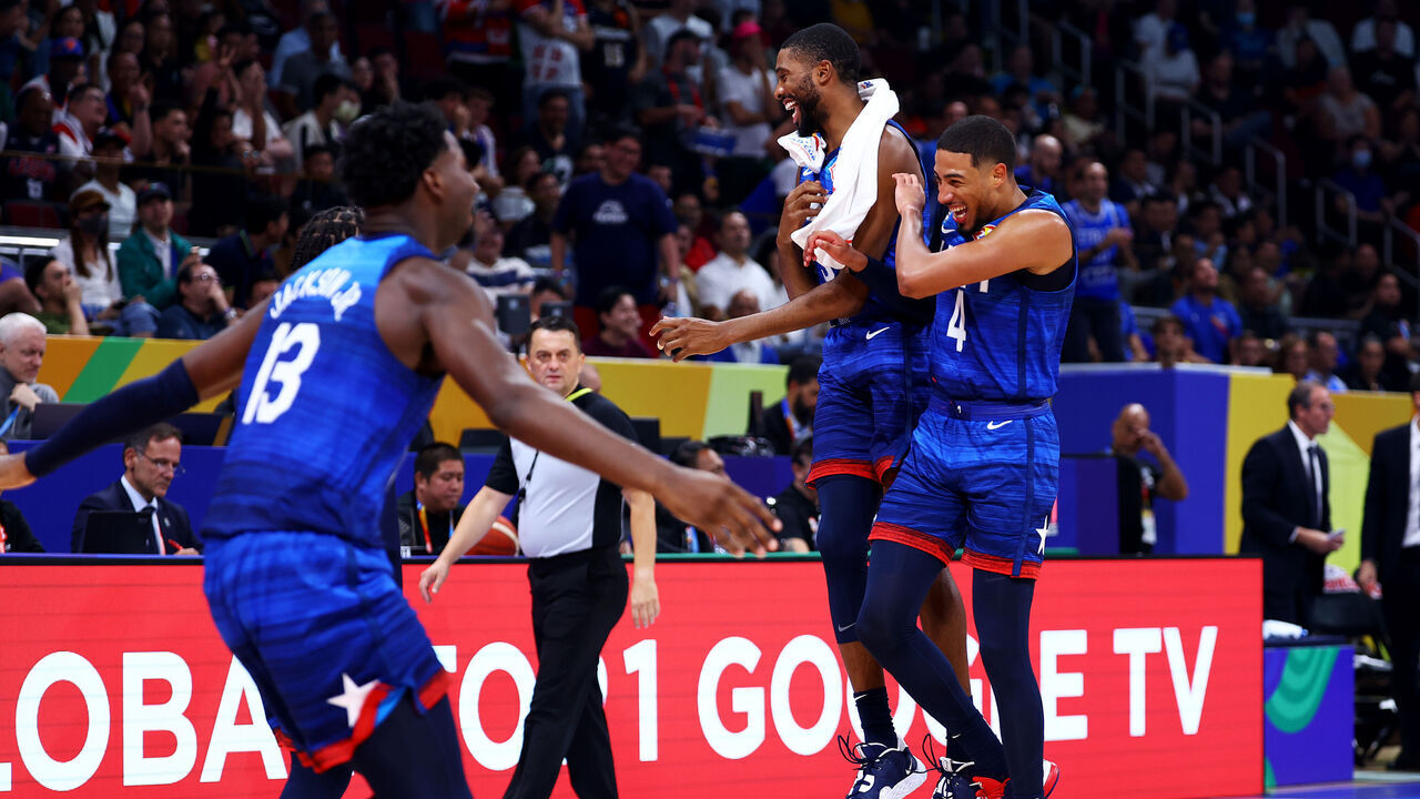 MANILA, PHILIPPINES - SEPTEMBER 05: Tyrese Haliburton #4 (R) and Mikal Bridges #5 of the United States celebrate after a dunk by Paolo Banchero #8 (not pictured) to end the third quarter during the FIBA Basketball World Cup quarterfinal game against Italy at Mall of Asia Arena on September 05, 2023 in Manila, Philippines.