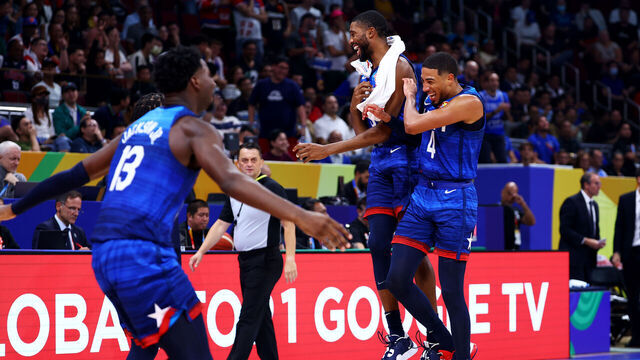 MANILA, PHILIPPINES - SEPTEMBER 05: Tyrese Haliburton #4 (R) and Mikal Bridges #5 of the United States celebrate after a dunk by Paolo Banchero #8 (not pictured) to end the third quarter during the FIBA Basketball World Cup quarterfinal game against Italy at Mall of Asia Arena on September 05, 2023 in Manila, Philippines.