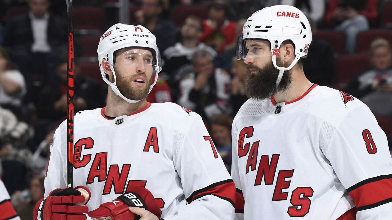 CHICAGO, ILLINOIS - NOVEMBER 14: Jaccob Slavin #74 and Brent Burns #8 of the Carolina Hurricanes talk in the third period against the Chicago Blackhawks at United Center on November 14, 2022 in Chicago, Illinois.