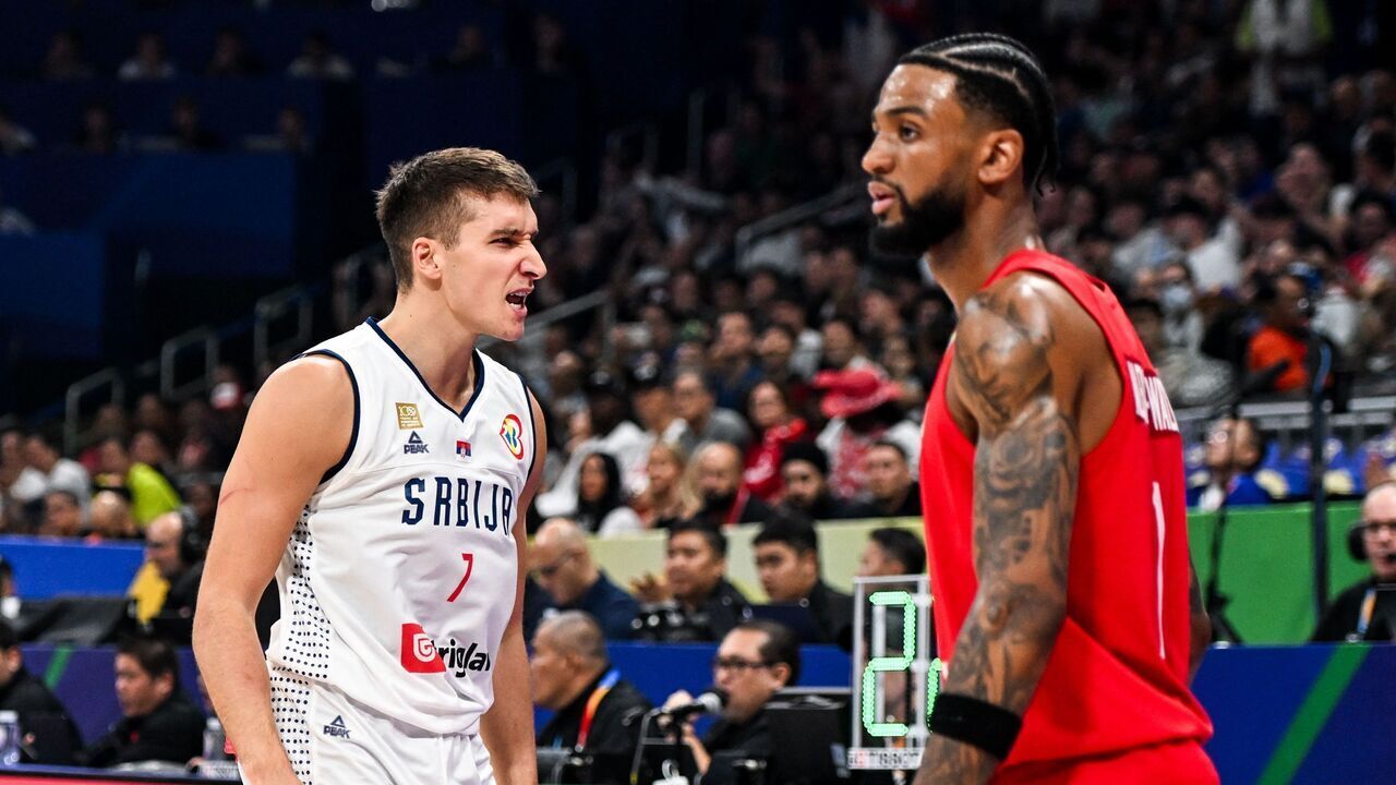Serbia's Bogdan Bogdanovic (L) reacts during the FIBA Basketball World Cup semi-final match between Serbia and Canada in Manila on September 8, 2023.