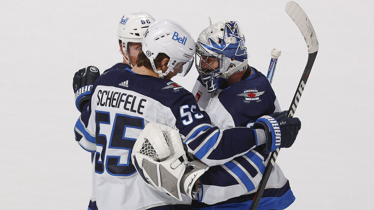 SUNRISE, FL - MARCH 11:Goaltender Connor Hellebuyck #37 celebrates the overtime win with Mark Scheifele #55 of the Winnipeg Jets against the Florida Panthers at the FLA Live Arena on March 11, 2023 in Sunrise, Florida.