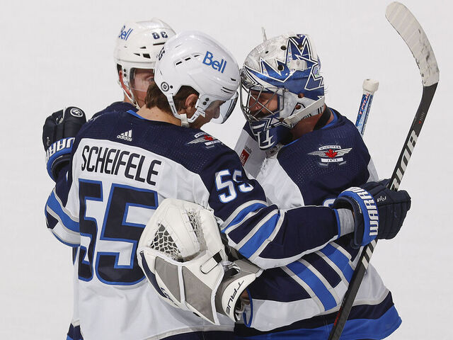 SUNRISE, FL - MARCH 11:Goaltender Connor Hellebuyck #37 celebrates the overtime win with Mark Scheifele #55 of the Winnipeg Jets against the Florida Panthers at the FLA Live Arena on March 11, 2023 in Sunrise, Florida.