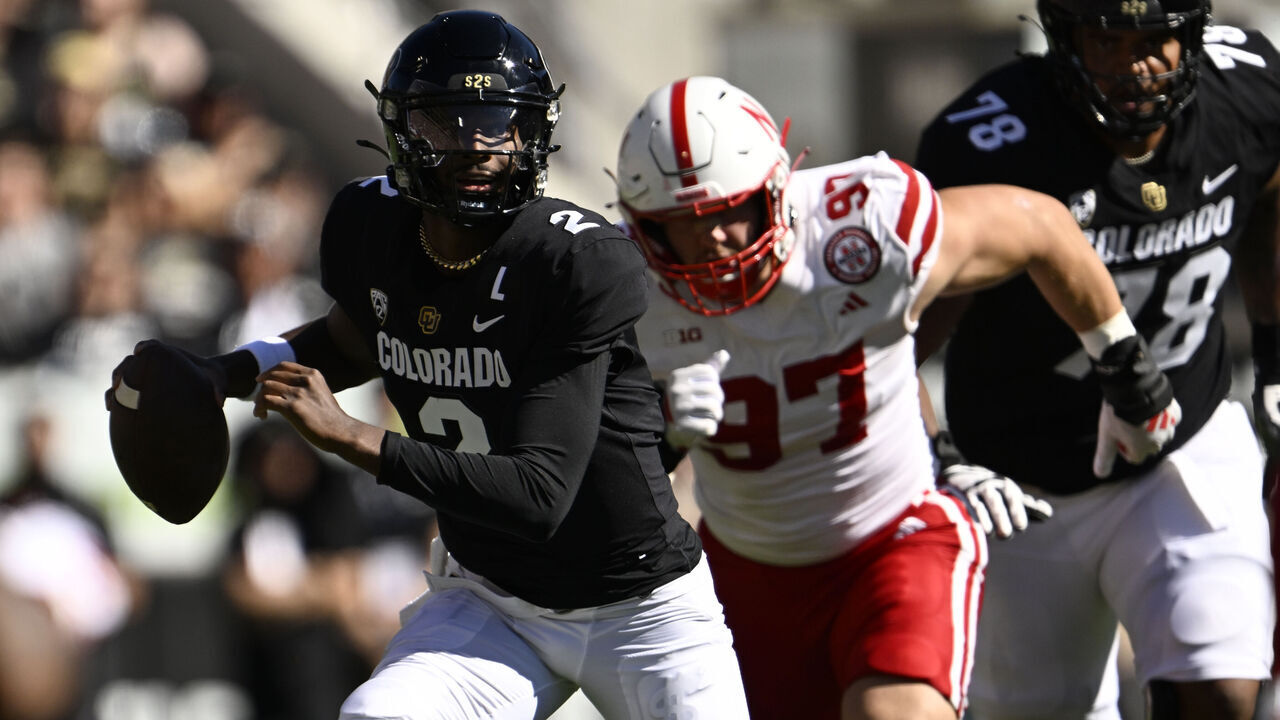 BOULDER, COLORADO - AUGUST 9: Colorado Buffaloes quarterback Shedeur Sanders (2) looks for somewhere to pass as he is be chased by Nebraska Cornhuskers defensive lineman Blaise Gunnerson (97) during the first half at Folsom Field on September 9, 2023 in Boulder, Colorado. Head Coach Deion Sanders led the Colorado Buffaloes in a matchup against their long-time rivals, the Nebraska Cornhuskers, during Coach Prime's highly anticipated home debut.