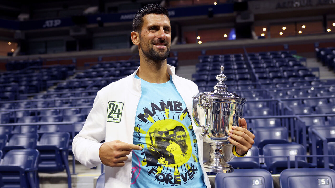 NEW YORK, NEW YORK - SEPTEMBER 10: Novak Djokovic of Serbia poses for the media with his winners trophy wearing a shirt as a tribute to the late Kobe Bryant after defeating Daniil Medvedev of Russia during their Men's Singles Final match on Day Fourteen of the 2023 US Open at the USTA Billie Jean King National Tennis Center on September 10, 2023 in the Flushing neighborhood of the Queens borough of New York City.