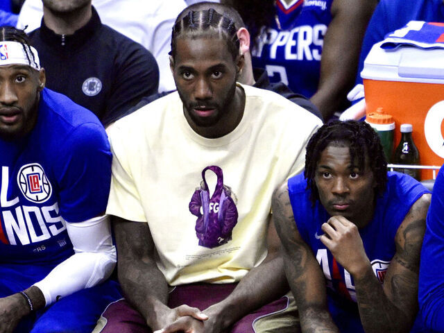 Los Angeles, - April 20: Kawhi Leonard, center, of the LA Clippers looks on from the bench in street clothes against of the Phoenix Suns in the first half of game 3 of a first round NBA playoff basketball game at the Crypto.com Arena in Los Angeles on Thursday, April 20, 2023.
