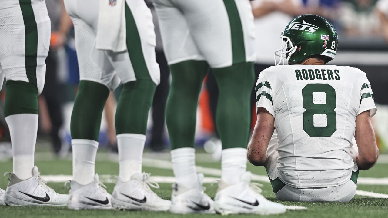 EAST RUTHERFORD, NEW JERSEY - SEPTEMBER 11: Aaron Rodgers #8 of the New York Jets sits down after an apparent injury after getting sacked by Leonard Floyd #56 of the Buffalo Bills prior to a game at MetLife Stadium on September 11, 2023 in East Rutherford, New Jersey.