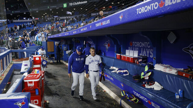 TORONTO, CANADA - SEPTEMBER 13: Daulton Varsho #25 of the Toronto Blue Jays leaves the dugout with hitting strategist Dave Hudgens after a 10-0 loss to the Texas Rangers at Rogers Centre on September 13, 2023 in Toronto, Canada.