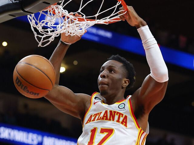 ATLANTA, GA - MARCH 21: Onyeka Okongwu #17 of the Atlanta Hawks dunks during the second half against the Detroit Pistons at State Farm Arena on March 21, 2023 in Atlanta, Georgia.