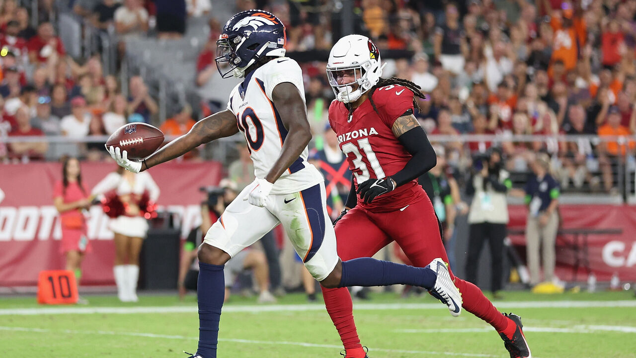 GLENDALE, ARIZONA - AUGUST 11: Wide receiver Jerry Jeudy #10 of the Denver Broncos scores a 21-yard touchdown reception ahead of safety Andre Chachere #31 of the Arizona Cardinals during the first half of the NFL game at State Farm Stadium on August 11, 2023 in Glendale, Arizona. The Cardinals defeated the Broncos 18-17.