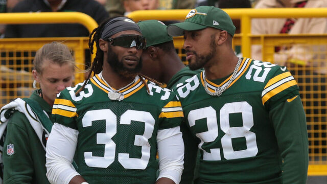 GREEN BAY, WI - AUGUST 26: Green Bay Packers running back Aaron Jones (33) and Green Bay Packers running back AJ Dillon (28) watch play during a game between the Green Bay Packers and the Seattle Seahawks at Lambeau Field on August 26, 2023 in Green Bay, WI.