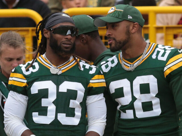 GREEN BAY, WI - AUGUST 26: Green Bay Packers running back Aaron Jones (33) and Green Bay Packers running back AJ Dillon (28) watch play during a game between the Green Bay Packers and the Seattle Seahawks at Lambeau Field on August 26, 2023 in Green Bay, WI.