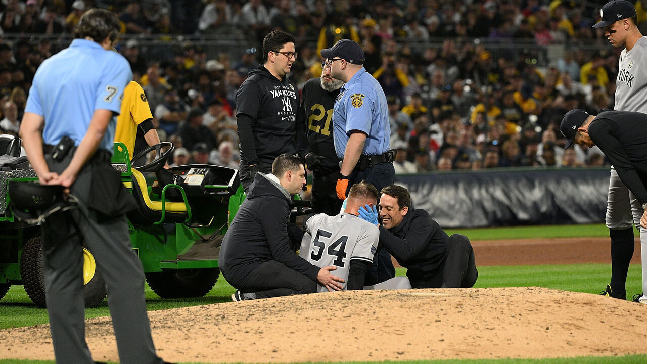 PITTSBURGH, PENNSYLVANIA - SEPTEMBER 15: Anthony Misiewicz #54 of the New York Yankees is checked out by trainers and medical staff after being hit by a ball off the bat of Ji Hwan Bae #3 of the Pittsburgh Pirates (not pictured) in the sixth inning during the game at PNC Park on September 15, 2023 in Pittsburgh, Pennsylvania. Players are wearing number 21 in honor of Roberto Clemente Day.