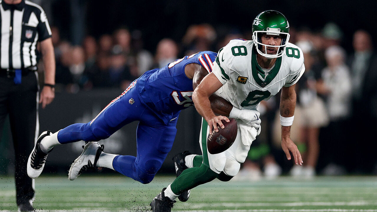EAST RUTHERFORD, NEW JERSEY - SEPTEMBER 11: Aaron Rodgers #8 of the New York Jets is sacked by Leonard Floyd #56 of the Buffalo Bills in the first quarter at MetLife Stadium on September 11, 2023 in East Rutherford, New Jersey. Rodgers was helped off the field after this play.