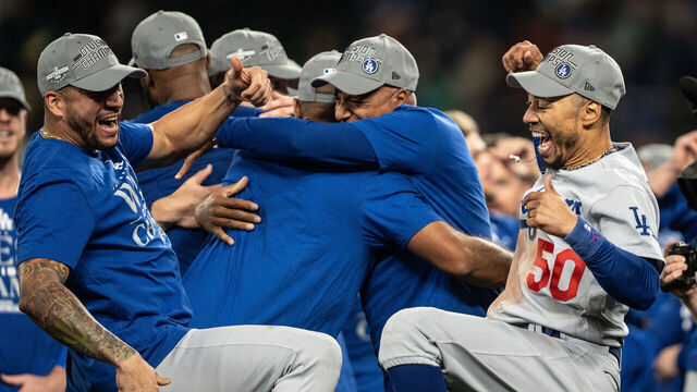 SEATTLE, WA - SEPTEMBER 16: Los Angeles Dodgers including Mookie Betts #50 celebrate after a game against the Seattle Mariners in which the team clinched the National League West Division title at T-Mobile Park on September 16, 2023 in Seattle, Washington. The Dodgers won 6-2 in 11 innings.