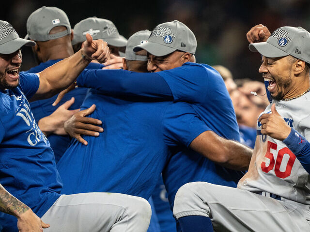 SEATTLE, WA - SEPTEMBER 16: Los Angeles Dodgers including Mookie Betts #50 celebrate after a game against the Seattle Mariners in which the team clinched the National League West Division title at T-Mobile Park on September 16, 2023 in Seattle, Washington. The Dodgers won 6-2 in 11 innings.