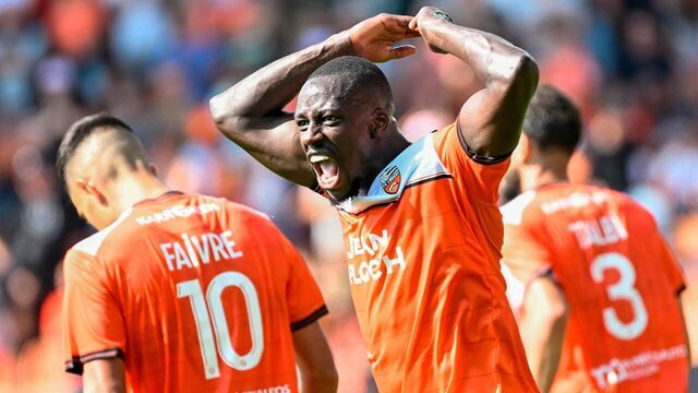 TOPSHOT - Lorient's French defender #05 Benjamin Mendy reacts after his team's second goal by Lorient's French midfielder #10 Romain Faivre during the French L1 football match between FC Lorient and AS Monaco at Stade du Moustoir in Lorient, western France on September 17, 2023.