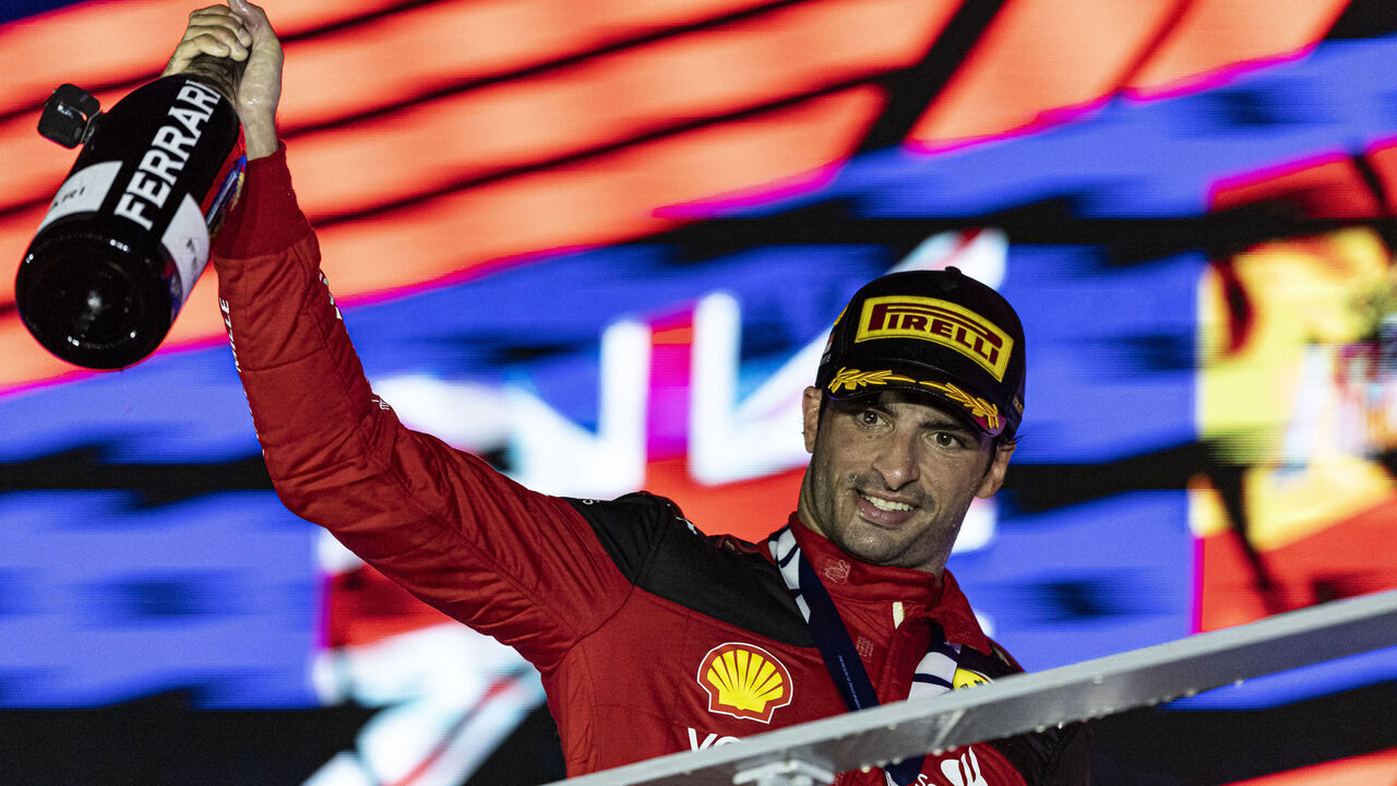 SINGAPORE, SINGAPORE - SEPTEMBER 17: Race winner Carlos Sainz Jr of Spain and Scuderia Ferrari celebrates on the podium during during the F1 Grand Prix of Singapore at Marina Bay Street Circuit on September 17, 2023 in Singapore, Singapore.