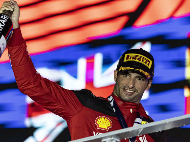 SINGAPORE, SINGAPORE - SEPTEMBER 17: Race winner Carlos Sainz Jr of Spain and Scuderia Ferrari celebrates on the podium during during the F1 Grand Prix of Singapore at Marina Bay Street Circuit on September 17, 2023 in Singapore, Singapore.