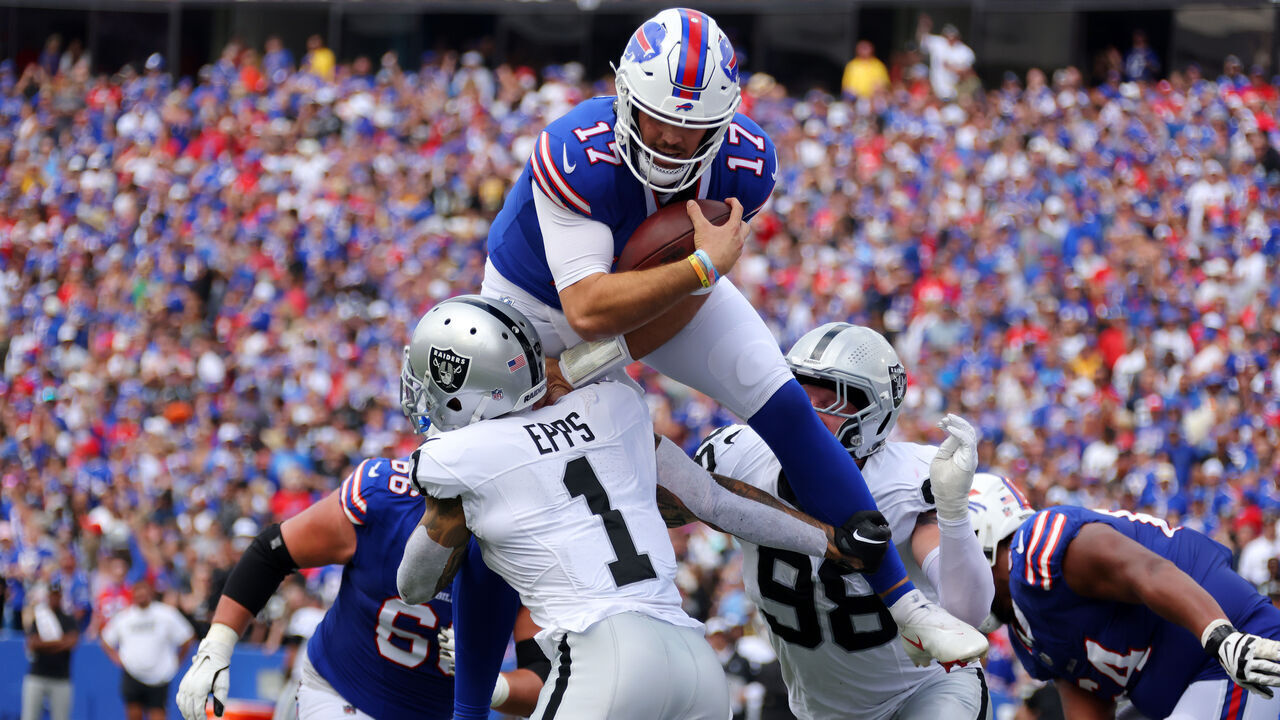 ORCHARD PARK, NEW YORK - SEPTEMBER 17: Josh Allen #17 of the Buffalo Bills attempts to leap over Marcus Epps #1 of the Las Vegas Raiders during the second quarter at Highmark Stadium on September 17, 2023 in Orchard Park, New York.