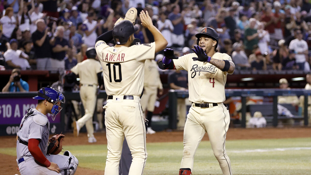 PHOENIX, ARIZONA - SEPTEMBER 17: Ketel Marte #4 of the Arizona Diamondbacks celebrates with Jordan Lawlar #10 after hitting a two run home run during the sixth inning against the Chicago Cubs at Chase Field on September 17, 2023 in Phoenix, Arizona.