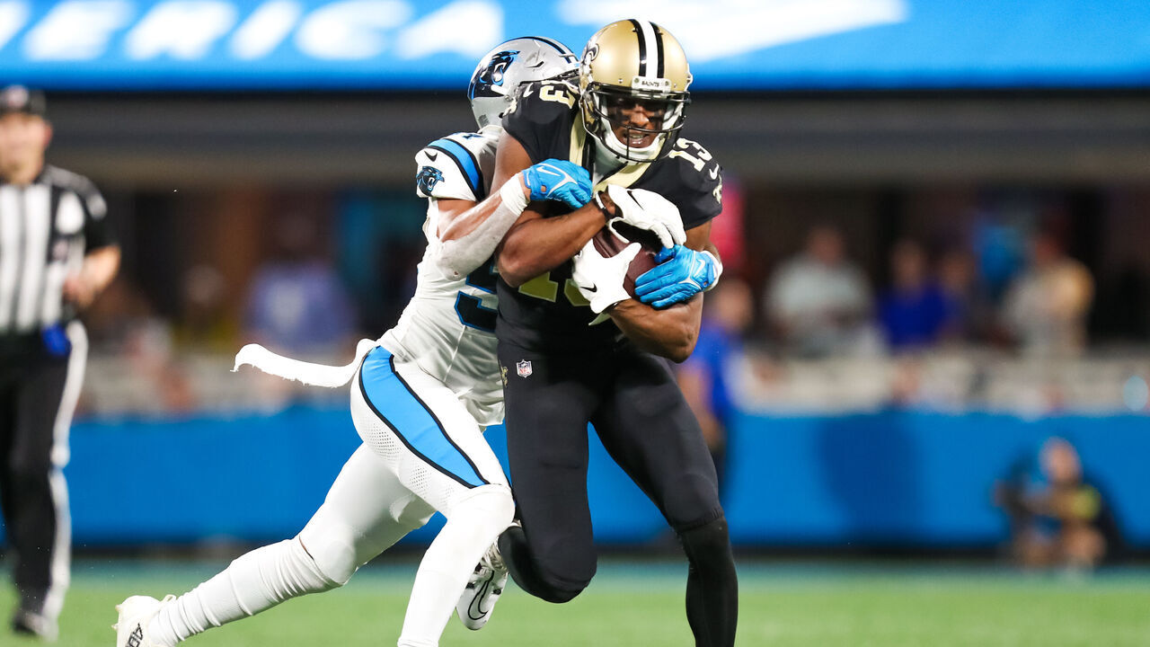 CHARLOTTE, NC - SEPTEMBER 18: Kamu Grugier-Hill #54 of the Carolina Panthers attempts to tackle Michael Thomas #13 of the New Orleans Saints during a football game at Bank of America Stadium in Charlotte, North Carolina on Sep 18, 2023.