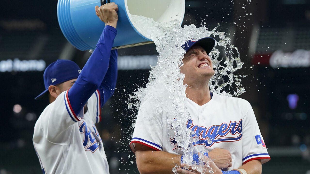 ARLINGTON, TEXAS - SEPTEMBER 19: Josh Jung #6 of the Texas Rangers is doused with water by Martin Perez #54 after the game against the Boston Red Sox at Globe Life Field on September 19, 2023 in Arlington, Texas.