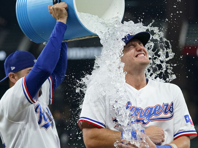ARLINGTON, TEXAS - SEPTEMBER 19: Josh Jung #6 of the Texas Rangers is doused with water by Martin Perez #54 after the game against the Boston Red Sox at Globe Life Field on September 19, 2023 in Arlington, Texas.