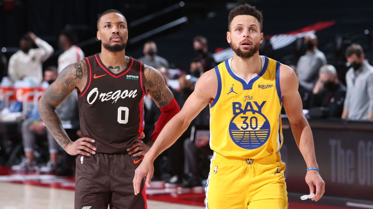 PORTLAND, OR - MARCH 3: Damian Lillard #0 of the Portland Trail Blazers and Stephen Curry #30 of the Golden State Warriors look on during the game on March 3, 2021 at the Moda Center Arena in Portland, Oregon. Mandatory Copyright Notice: Copyright 2021 NBAE