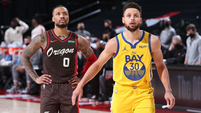 PORTLAND, OR - MARCH 3: Damian Lillard #0 of the Portland Trail Blazers and Stephen Curry #30 of the Golden State Warriors look on during the game on March 3, 2021 at the Moda Center Arena in Portland, Oregon. Mandatory Copyright Notice: Copyright 2021 NBAE
