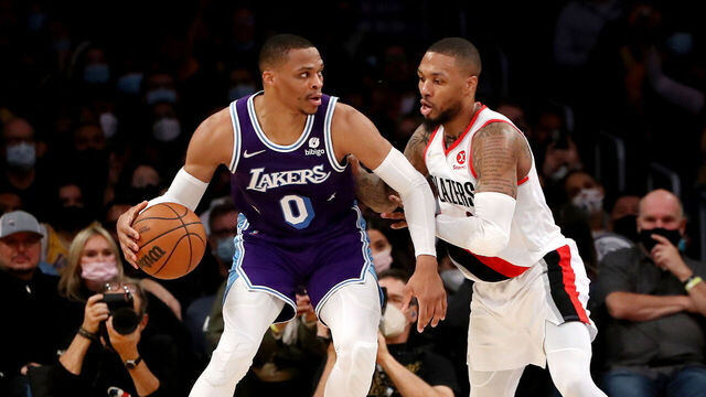 LOS ANGELES, CALIFORNIA - DECEMBER 31: Russell Westbrook #0 of the Los Angeles Lakers handles the ball against Damian Lillard #0 and Larry Nance Jr. #11 of the Portland Trail Blazers during the second quarter at Crypto.com Arena on December 31, 2021 in Los Angeles, California.