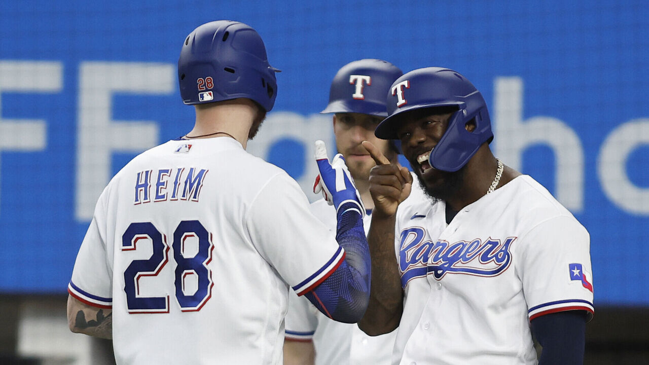 ARLINGTON, TEXAS - SEPTEMBER 20: Jonah Heim #28 of the Texas Rangers is congratulated by Adolis Garcia #53 of the Texas Rangers after hitting a three-run home run in the second inning against the Boston Red Sox at Globe Life Field on September 20, 2023 in Arlington, Texas.