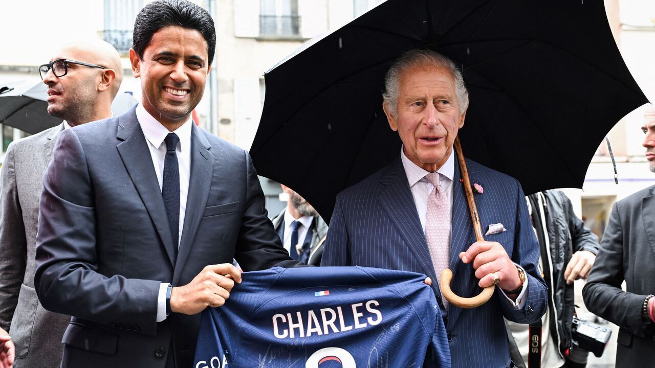 Paris Saint Germain's Qatari president Nasser al-Khelaifi offers Britain's King Charles III a Paris Saint Germain's jersey during a visit in Saint-Denis, northern suburb of Paris, home of the Rugby World Cup village, national stadium and venue for next year's Olympic Games, on September 21, 2023. Britain's King Charles III and his wife Queen Camilla are on a three-day state visit starting on September 20, 2023, to Paris and Bordeaux, six months after rioting and strikes forced the last-minute postponement of his first state visit as king.