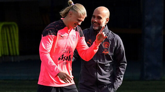 Manchester City's Erling Haaland (left) and manager Pep Guardiola during a training session at City Football Academy, Manchester. Picture date: Monday September 18, 2023.