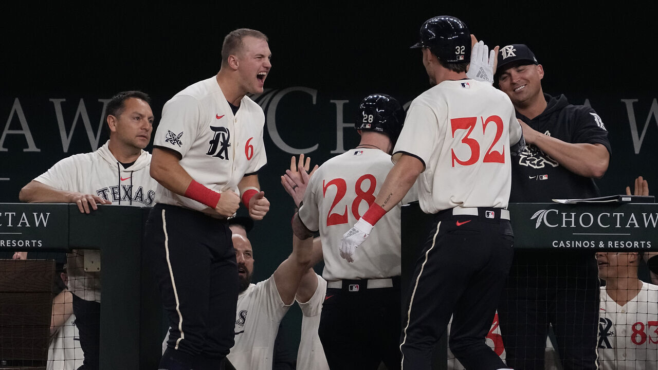 ARLINGTON, TEXAS - SEPTEMBER 22: Evan Carter #32 of the Texas Rangers celebrates with Josh Jung #6 after hitting a three-run home run during the third inning against the Seattle Mariners at Globe Life Field on September 22, 2023 in Arlington, Texas.
