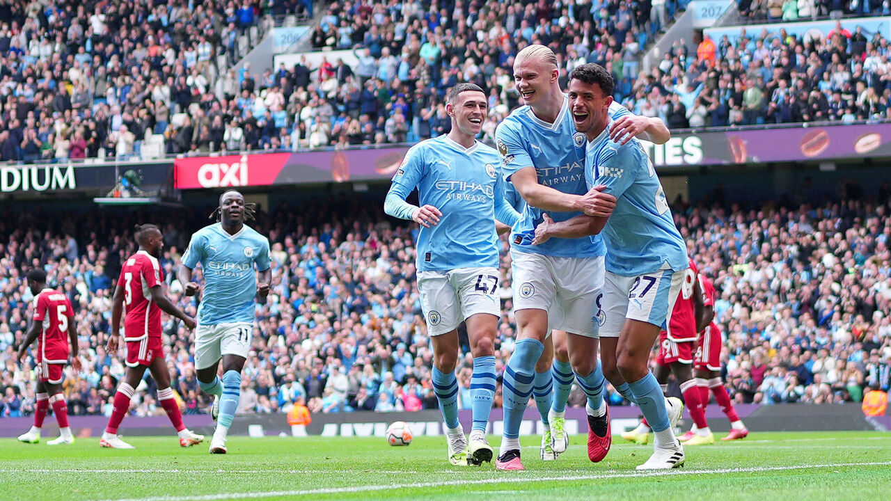 MANCHESTER, ENGLAND - SEPTEMBER 23: Erling Haaland of Manchester City celebrates with team mate Phil Foden and Matheus Nunes of Manchester City after scoring their sides second goal during the Premier League match between Manchester City and Nottingham Forest at Etihad Stadium on September 23, 2023 in Manchester, England.