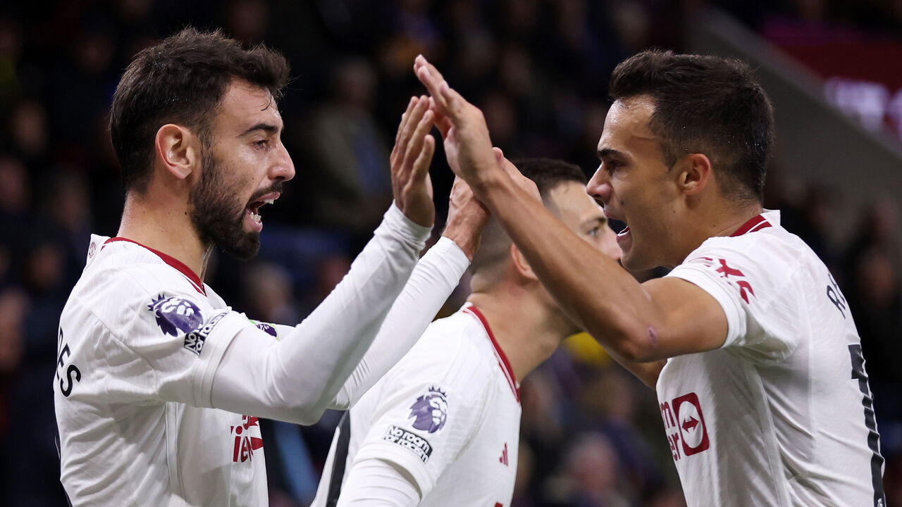 BURNLEY, ENGLAND - SEPTEMBER 23: Bruno Fernandes of Manchester United celebrates with team mate Sergio Reguilon after scoring their sides first goal during the Premier League match between Burnley FC and Manchester United at Turf Moor on September 23, 2023 in Burnley, England.