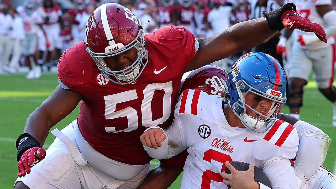 TUSCALOOSA, ALABAMA - SEPTEMBER 23: Jaxson Dart #2 of the Mississippi Rebels is tackled by Tim Smith #50 and Jihaad Campbell #30 of the Alabama Crimson Tide during the third quarter at Bryant-Denny Stadium on September 23, 2023 in Tuscaloosa, Alabama.