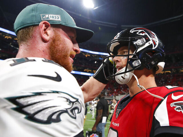ATLANTA, GA - SEPTEMBER 15: Matt Ryan #2 of the Atlanta Falcons speaks with Carson Wentz #11 of the Philadelphia Eagles following an NFL game at Mercedes-Benz Stadium on September 15, 2019 in Atlanta, Georgia.