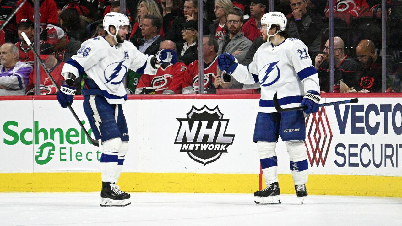 RALEIGH, NC - MARCH 28: Tampa Bay Lightning Right Wing Nikita Kucherov (86) and Tampa Bay Lightning Center Brayden Point (21) celebrate scoring a goal during the game between the Tampa Bay Lightning and the Carolina Hurricanes on March 28, 2023 at PNC Arena in Raleigh, North Carolina.