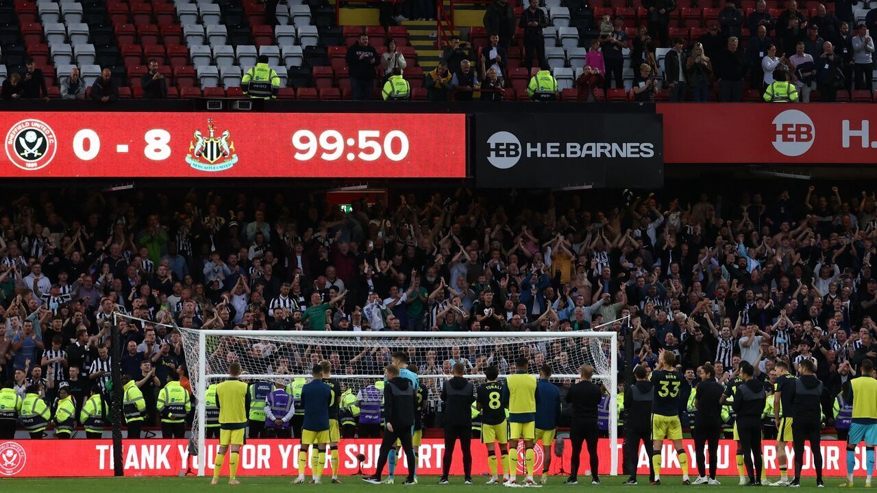 Newcastle players celebrate in front of their fans after the English Premier League football match between Sheffield United and Newcastle United at Bramall Lane in Sheffield, northern England on September 24, 2023. Newcastle won the game 8-0.