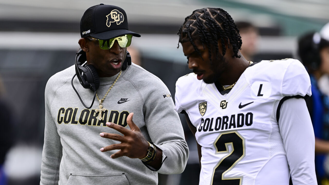 EUGENE, OR - SEPTEMBER 23: Colorado Buffaloes head coach Deion Sanders talks with his son Colorado Buffaloes quarterback Shedeur Sanders (2) before the game against the Oregon Ducks at Autzen Stadium September 23, 2023.