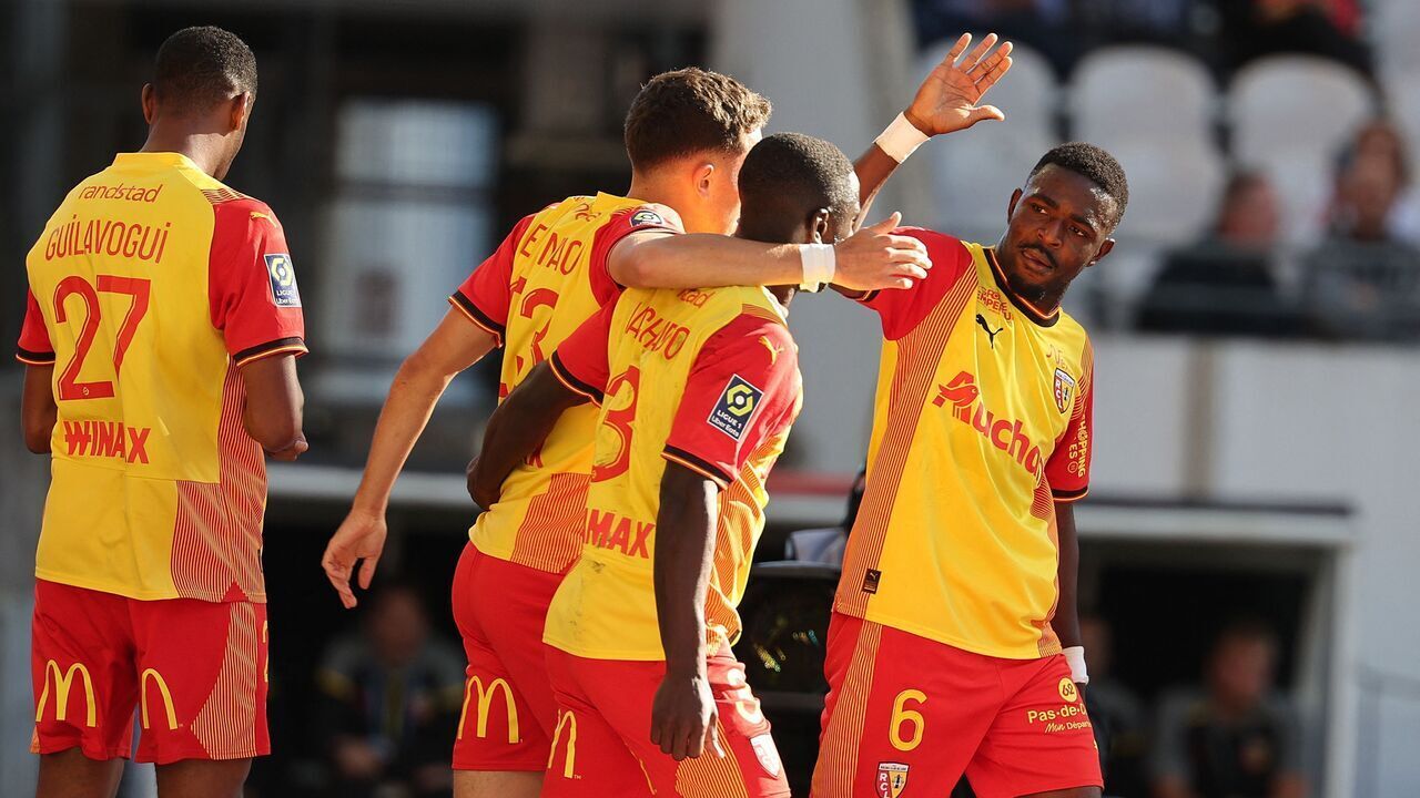 Lens' French Guinean forward #27 Morgan Guilavogui (L) celebrates with Lens' Ghanaian midfielder #06 Salis Abdul Samed (R) and teammates after he scored the second goal for his team during the French L1 football match between RC Lens and Toulouse FC at Stade Bollaert-Delelis in Lens, northern France on September 24, 2023.