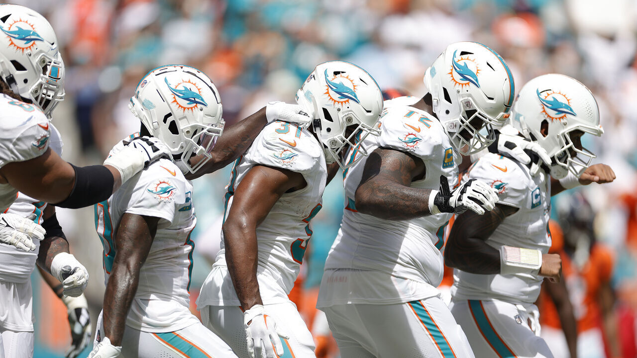 MIAMI GARDENS, FLORIDA - SEPTEMBER 24: Tyreek Hill #10 of the Miami Dolphins and Raheem Mostert #31 of the Miami Dolphins, Terron Armstead #72 of the Miami Dolphins, and Tua Tagovailoa #1 of the Miami Dolphins celebrate after Mostert's rushing touchdown during the second quarter against the Denver Broncos at Hard Rock Stadium on September 24, 2023 in Miami Gardens, Florida.