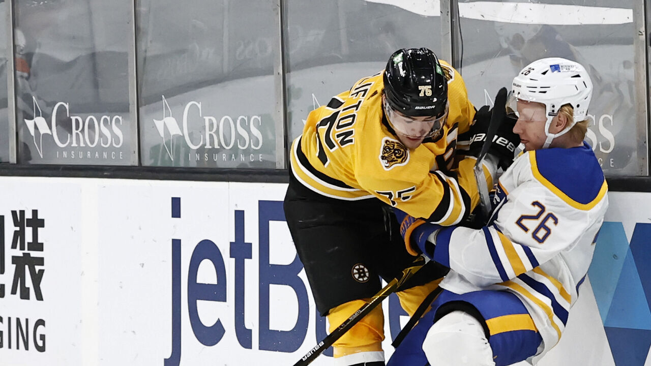 BOSTON, MA - MARCH 27: Boston Bruins defenseman Connor Clifton (75) hits Buffalo Sabres defenseman Rasmus Dahlin (26) during a game between the Boston Bruins and the Buffalo Sabres on March 27, 2021, at TD Garden in Boston, Massachusetts.