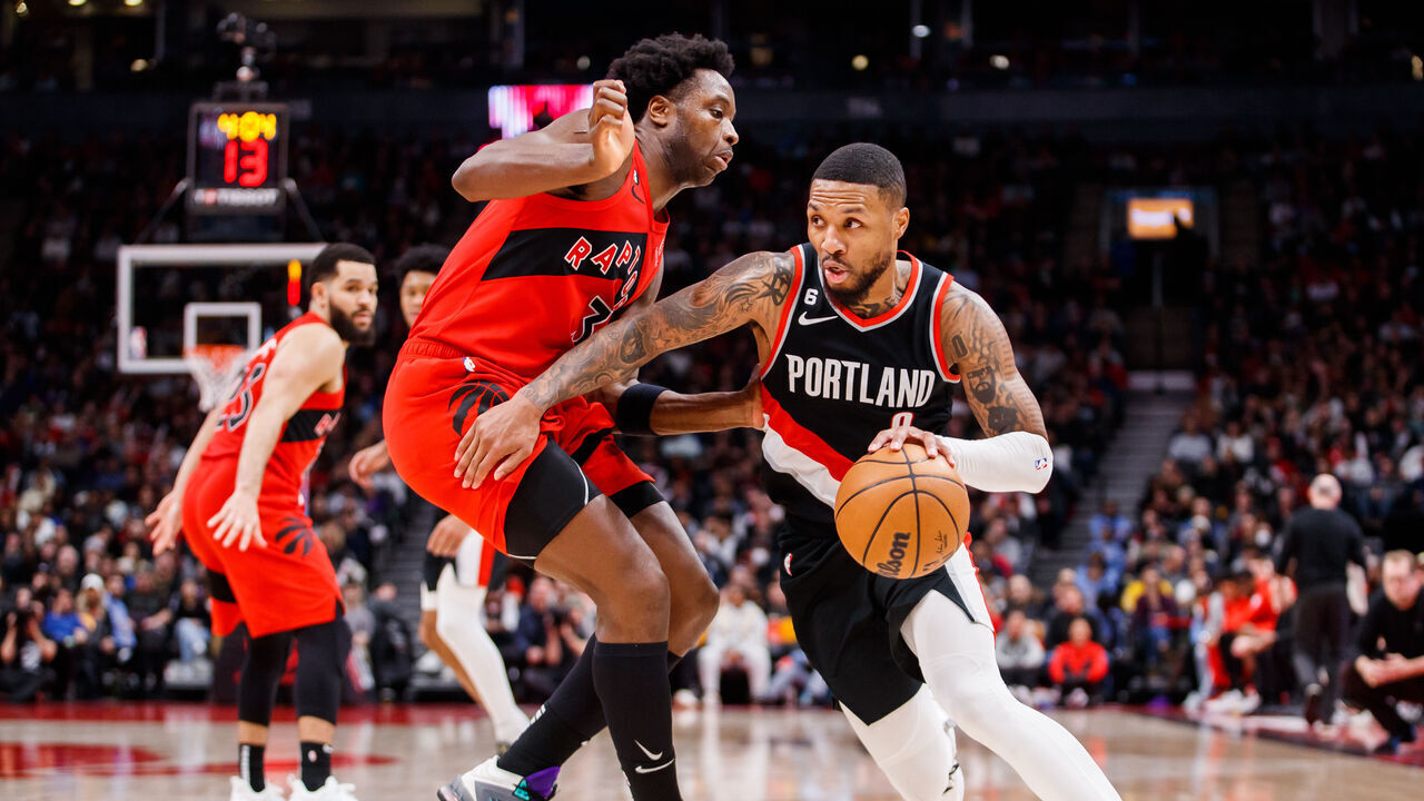 TORONTO, ON - JANUARY 08: Damian Lillard #0 of the Portland Trail Blazers drives to the net against O.G. Anunoby #3 of the Toronto Raptors during the second half of their NBA game at Scotiabank Arena on January 8, 2023 in Toronto, Canada.