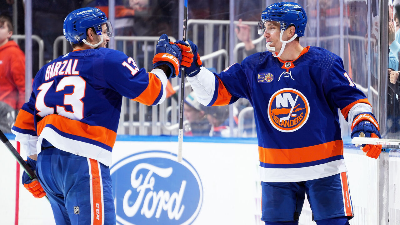 ELMONT, NEW YORK - FEBRUARY 07: Bo Horvat #14 of the New York Islanders is congratulated by his teammate Mathew Barzal #13 after scoring a goal against the Seattle Kraken dsecond period at UBS Arena on February 07, 2023 in Elmont, New York.
