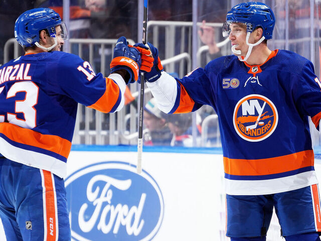 ELMONT, NEW YORK - FEBRUARY 07: Bo Horvat #14 of the New York Islanders is congratulated by his teammate Mathew Barzal #13 after scoring a goal against the Seattle Kraken dsecond period at UBS Arena on February 07, 2023 in Elmont, New York.