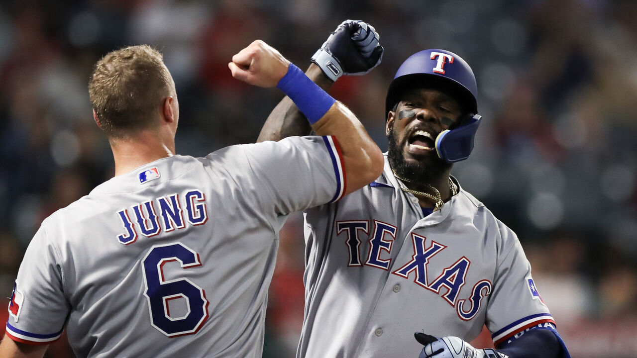 ANAHEIM, CALIFORNIA - SEPTEMBER 25: Adolis Garcia #53 of the Texas Rangers celebrates his home run with Josh Jung #6 in the sixth inning against the Los Angeles Angels at Angel Stadium of Anaheim on September 25, 2023 in Anaheim, California.
